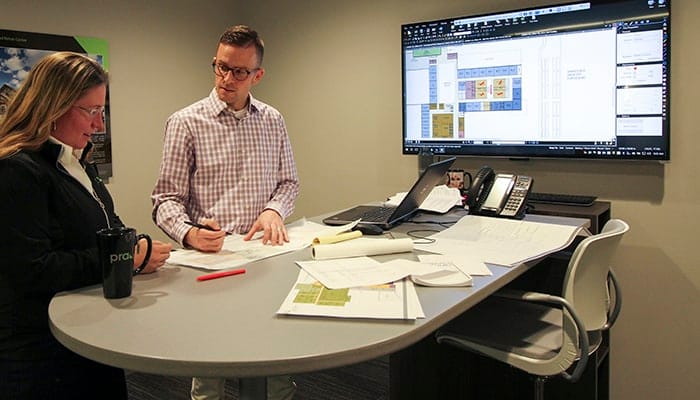 Education Architect Devin Kack collaborates with a member of the school design studio