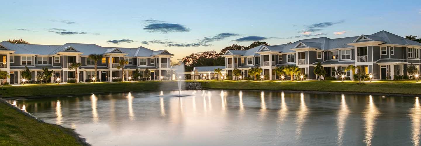 Multifamily Bergamot Apartments in Sarasota, FL overlook a water feature.