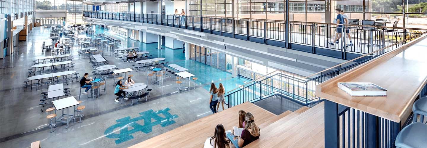 The student commons provide flexible space for large events or solo student work. Light, flexible furniture, durable materials, and easy access to learning centers are hallmarks of modern school design as shown at the Wisconsin Dells Highschool, in Wisconsin Dells, Wisconsin