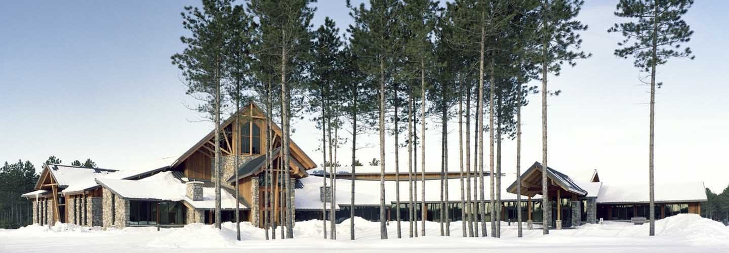 Holy Family Catholic Church in Woodruff, Wisconsin is designed to settle into the landscape and evoke wonder about God and nature, even in winter with design and architectural symbolism. Good church architecture is designed for all times of the day and seasons of the year