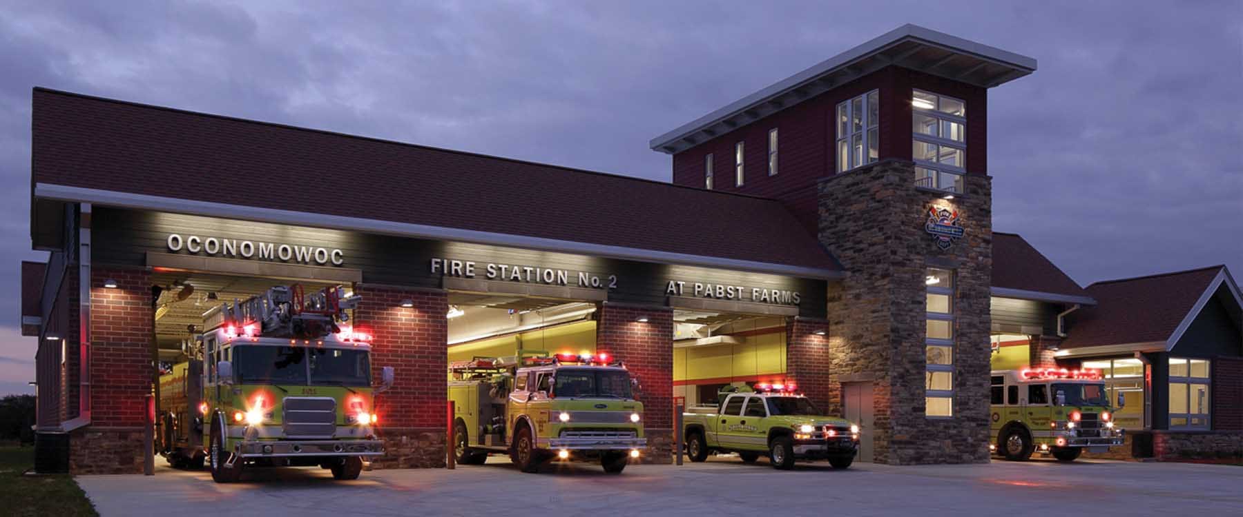 Oconomowoc Fire Station No. 2 Pabst Farm at dusk, apparatus responding, in Oconomowoc, Wisconsin